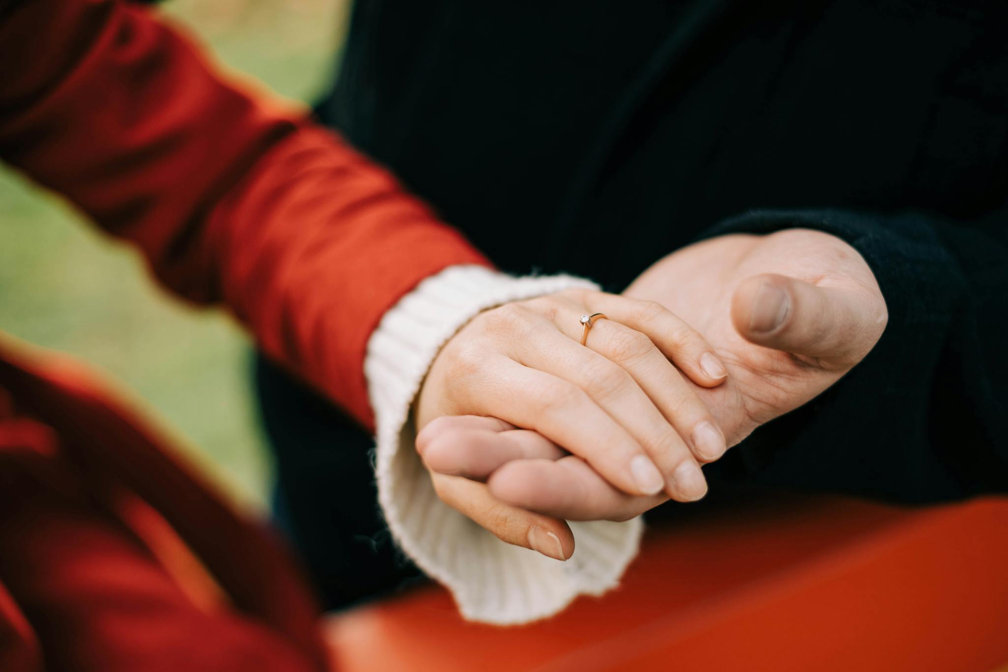 Close-up of two people holding hands, symbolizing support and connection.
